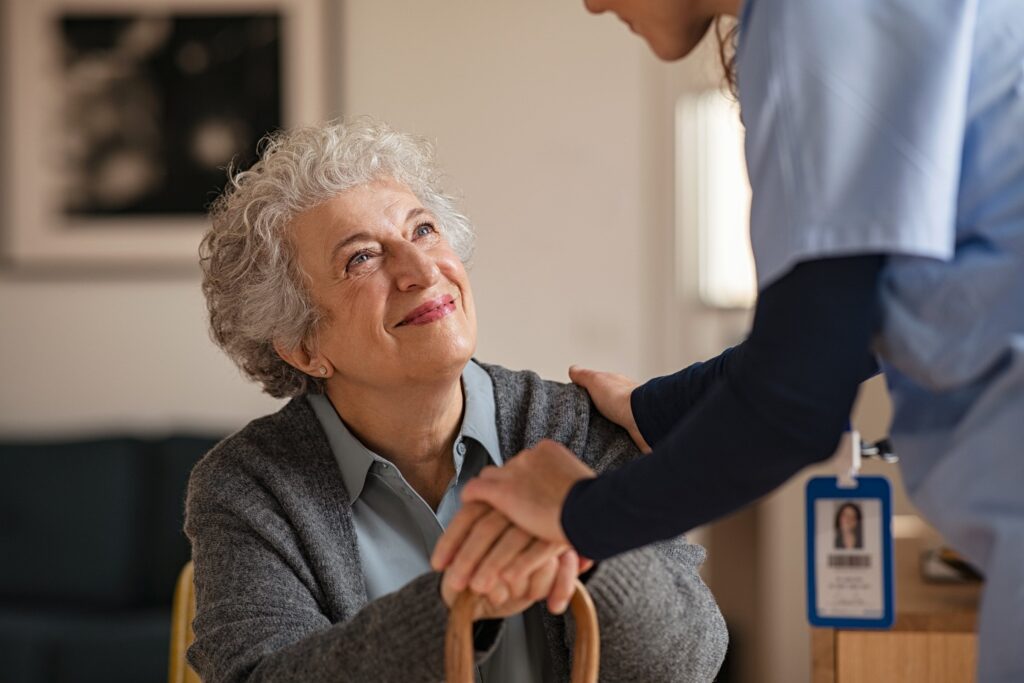 Elderly lady looking up at carer